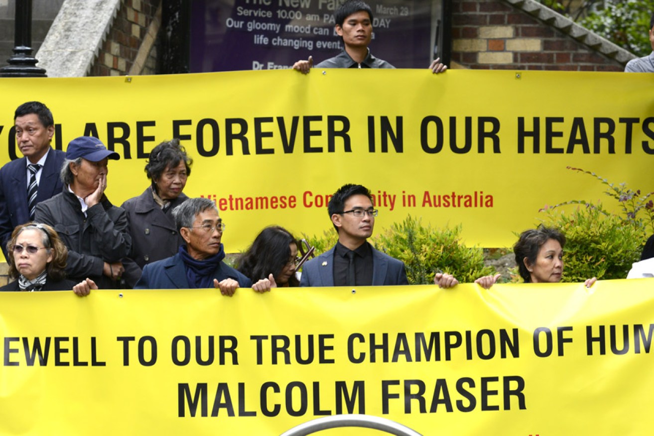 Members of the Vietnamese community in front of Scots' Church ahead of former prime minister Malcolm Fraser's funeral in Melbourne. Photo: AAP