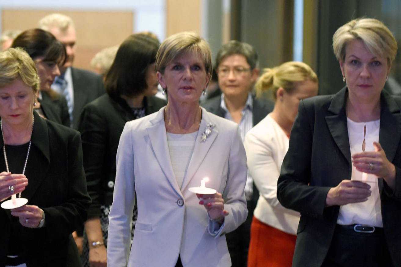 Foreign Minister Julie Bishop (centre) with Greens leader Christine Milne (left) Deputy Opposition Leader Tanya Plibersek (right) at a dawn candlelight vigil at Parliament House in Canberra, for Bali Nine ringleaders Myuran Sukumaran and Andrew Chan.