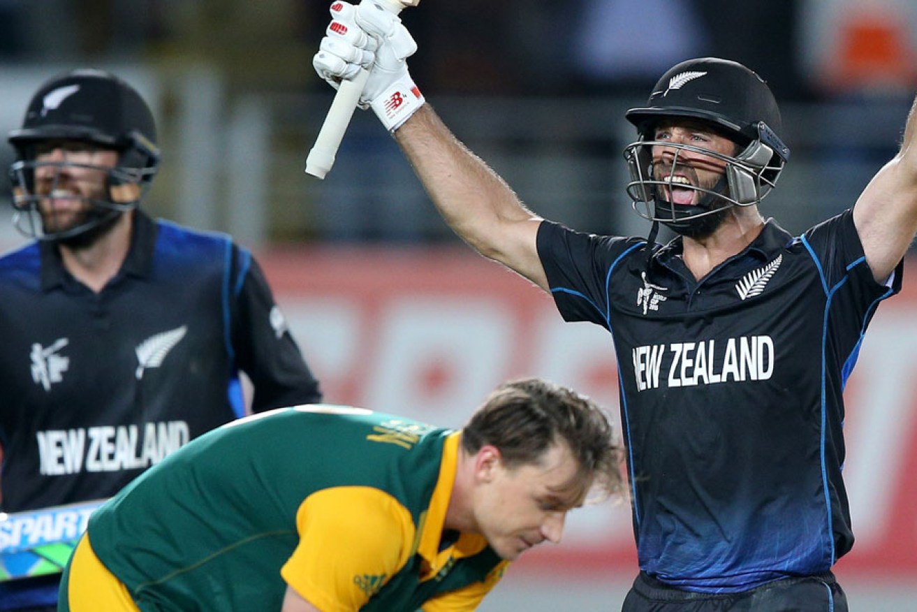 New Zealand’s Grant Elliott celebrates with teammate Dan Vettori as South Africa's Dale Steyn reacts after Elliott smashed a six to give the Black Caps victory.