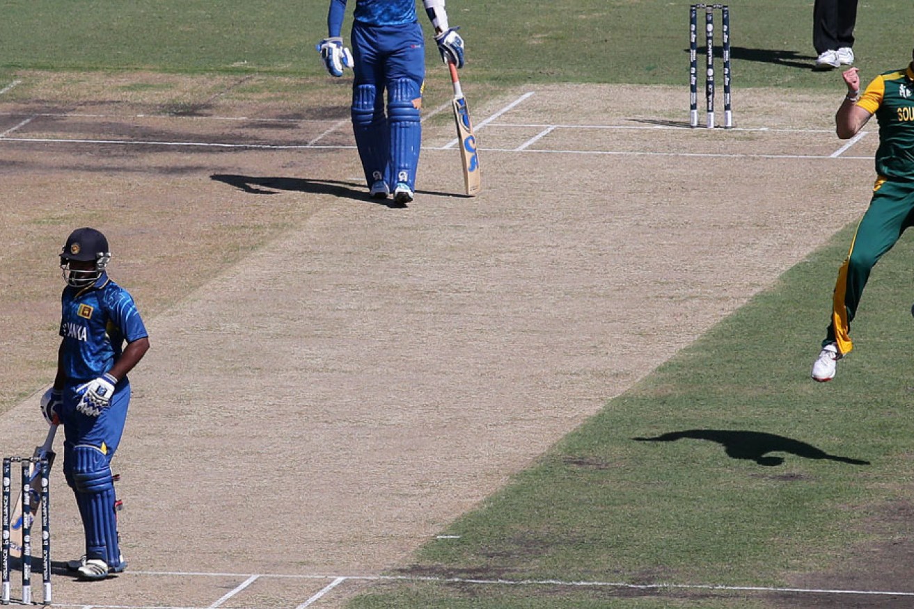 South Africa's Kyle Abbott celebrates after taking the wicket of Sri Lanka's Kusal Perera.