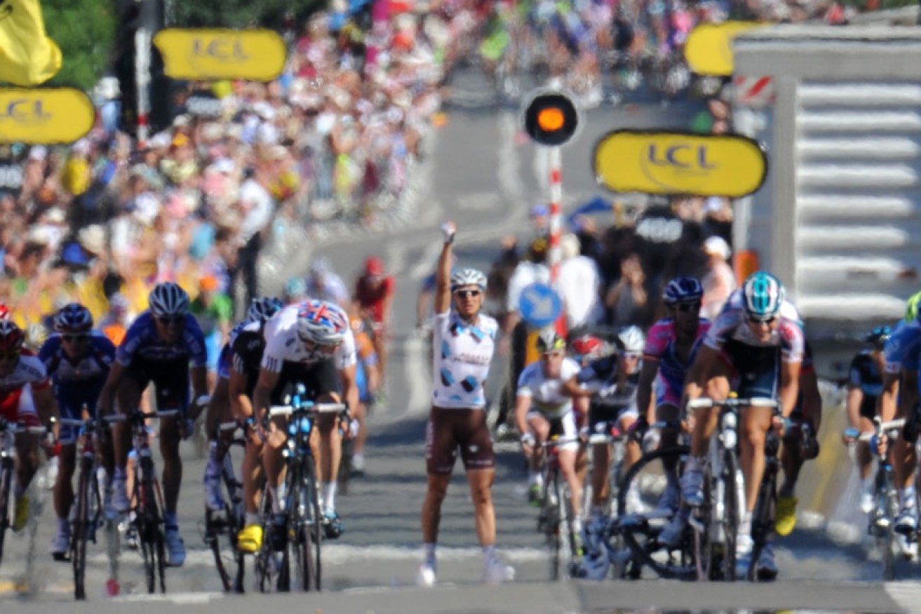Lloyd Mondory (centre) gestures after crashing near the finish line during the first stage of the 2010 Tour de France.