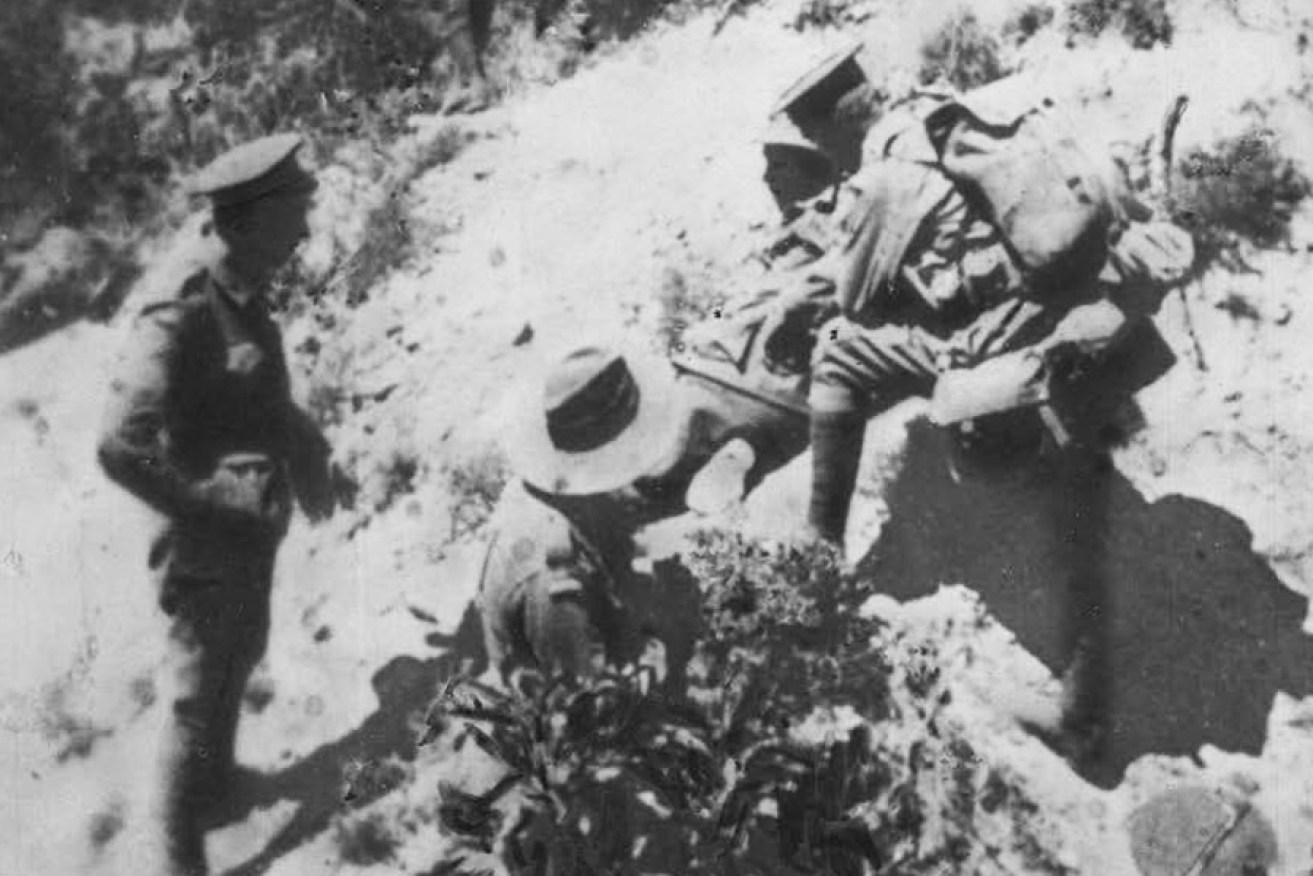 Barrie receiving assistance after being wounded at the Gallipoli landing.