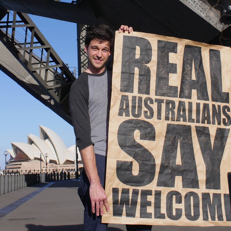 Peter Drew with one of his posters in Sydney.