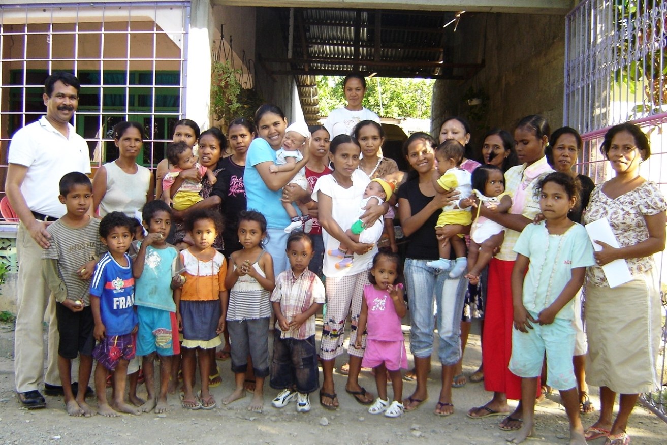 Dr Saikia (far left) with a group of mothers and children in Timor-Leste