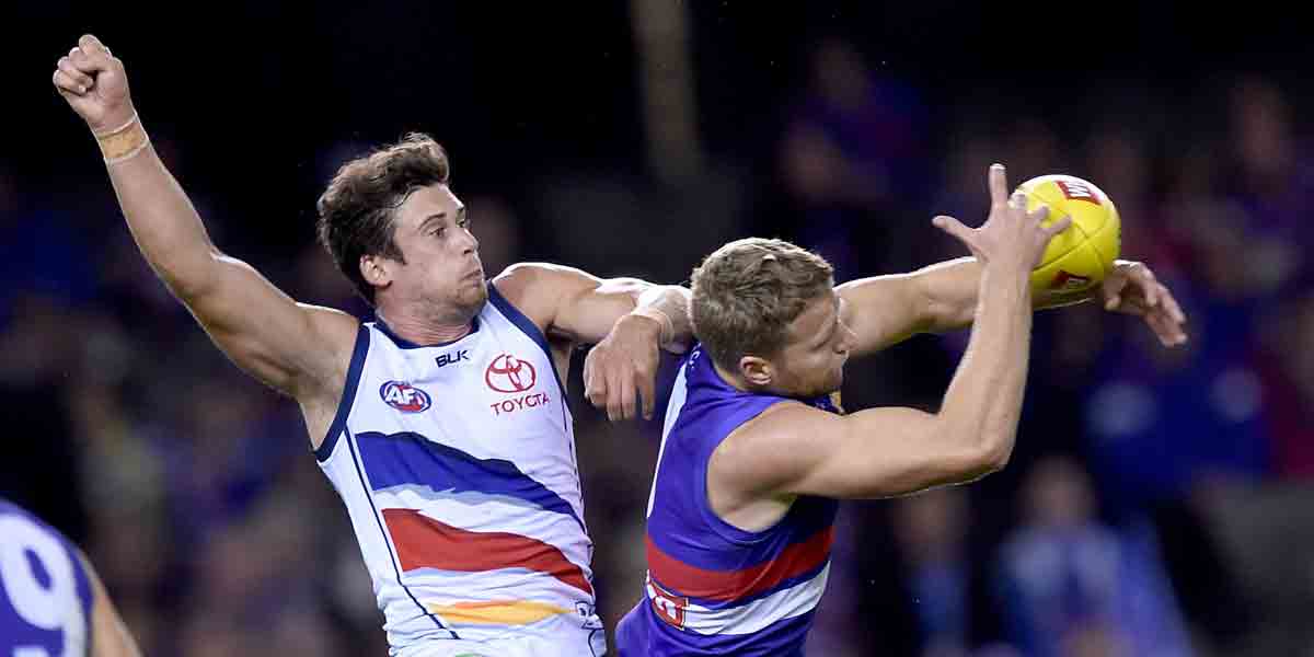 The Bulldogs' Jake Stringer on his way to a severe case of leather poisoning, while Kyle Hartigan punches the air. AAP photo