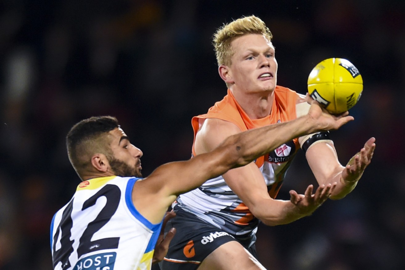 Adam Treloar (right) in action for the Giants.