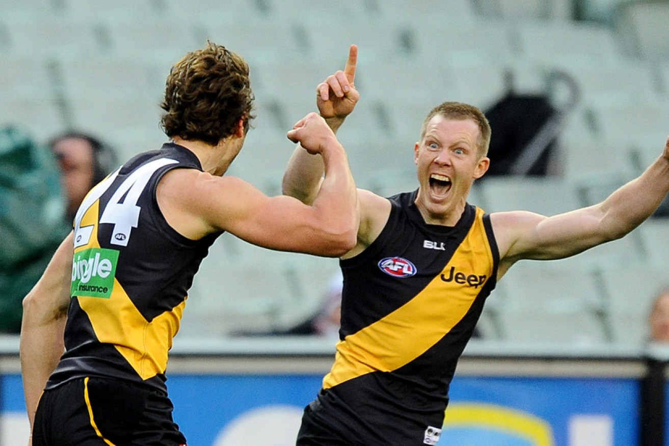 Ben Griffiths (left) celebrates with Jack Riewoldt during a 2014 match.