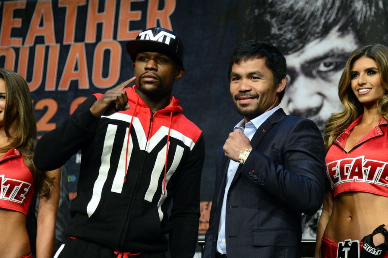 Pre-fight hype: Floyd Mayweather and Manny Pacquiao pose with models ahead of the weekend's bout.