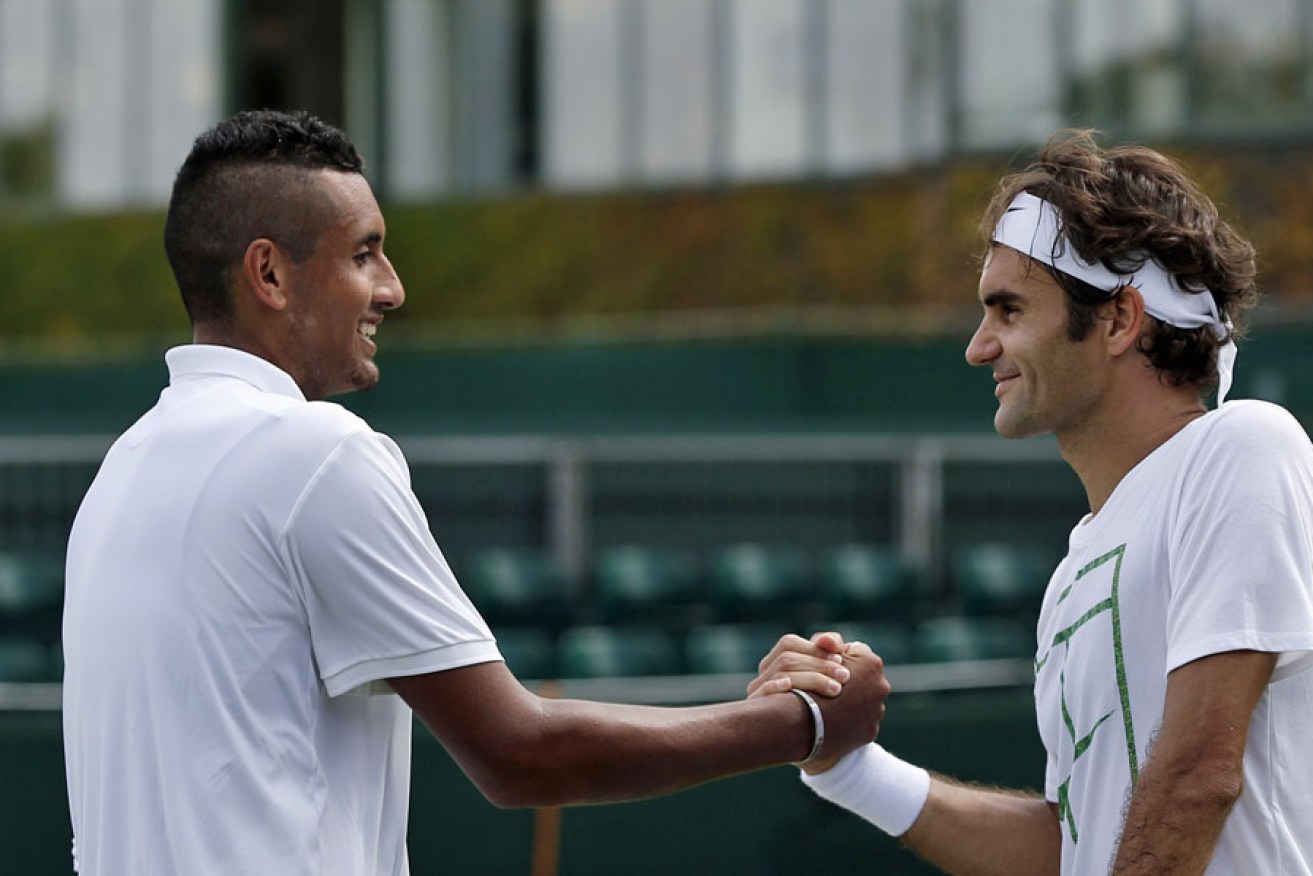 Switzerland's Roger Federer (right) shakes hands with Australia's Nick Kyrgios following a practice session ahead of the 2015 Wimbledon Championships.