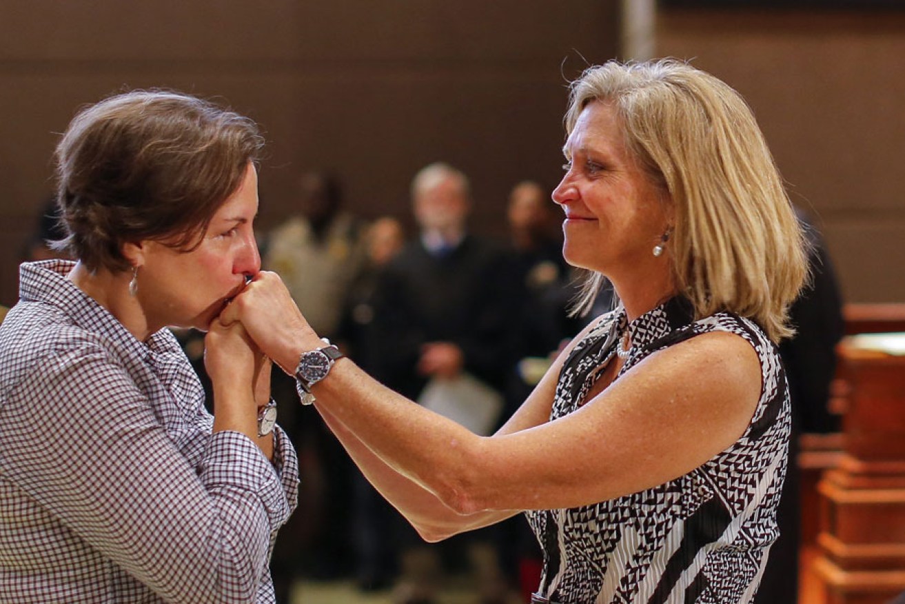 Melinda Brewer (left) and her new spouse Joan Crumpler after getting married during a mass ceremony in Atlanta, Georgia, just hours after the US Supreme Court ruled that gay marriage is a constitutional right.