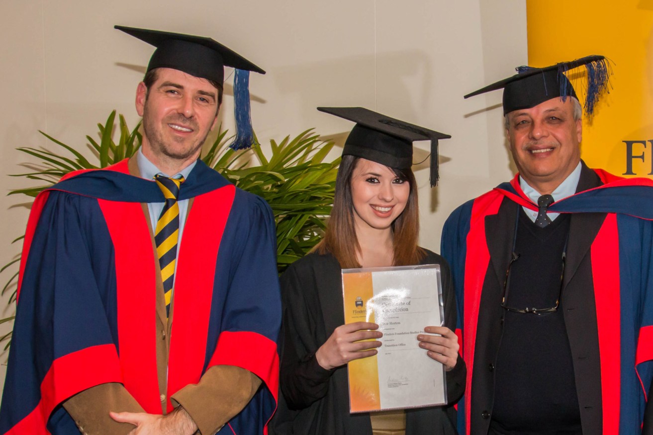 Zoe Horton flanked by Dr Michael Savvas (left) and Associate Professor Salah Kutieleh at the Foundation Studies completion ceremony