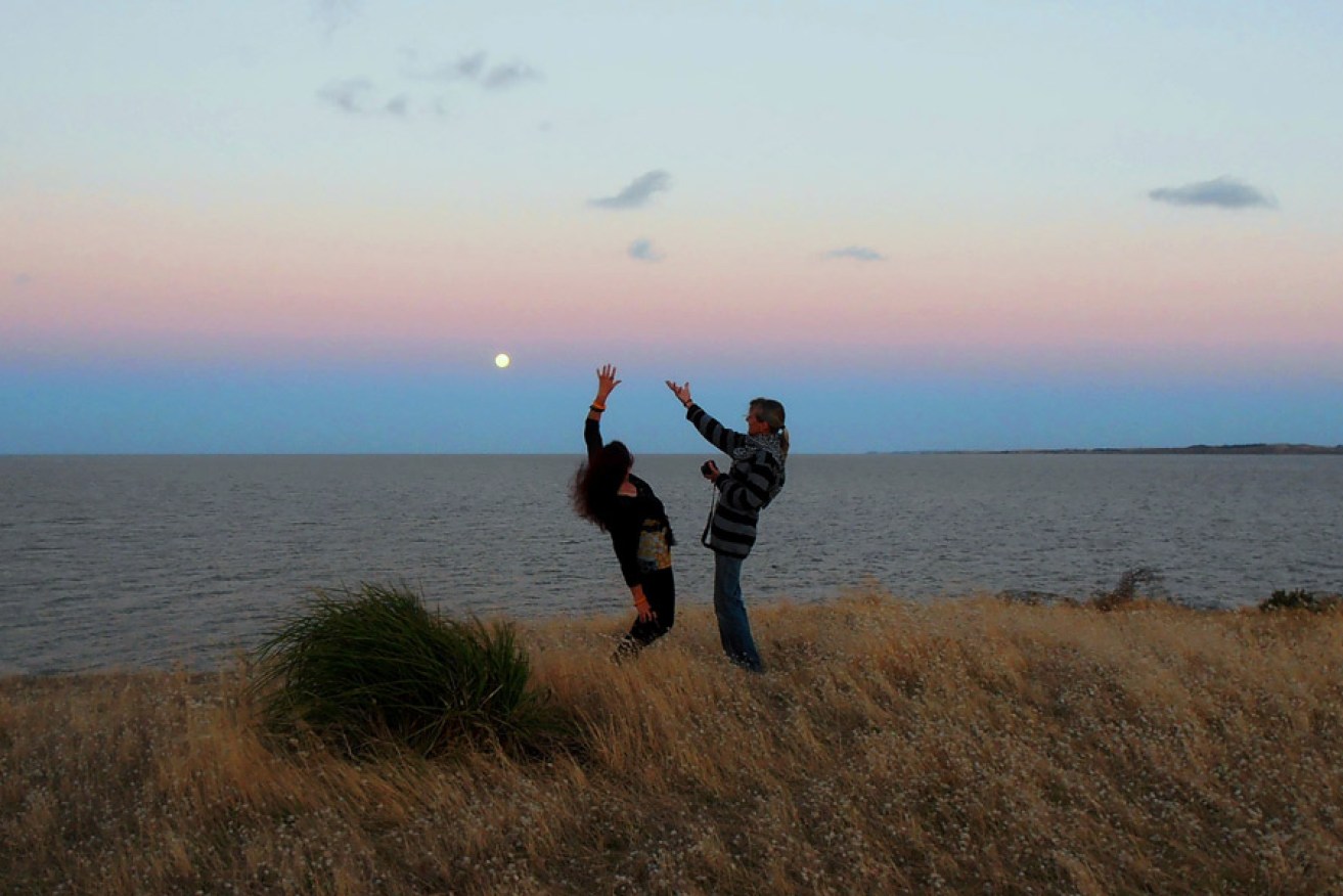 Annabelle Collett dancing with Sandy Mulcahy under the full moon at Point Sturt. Photo: Philip White