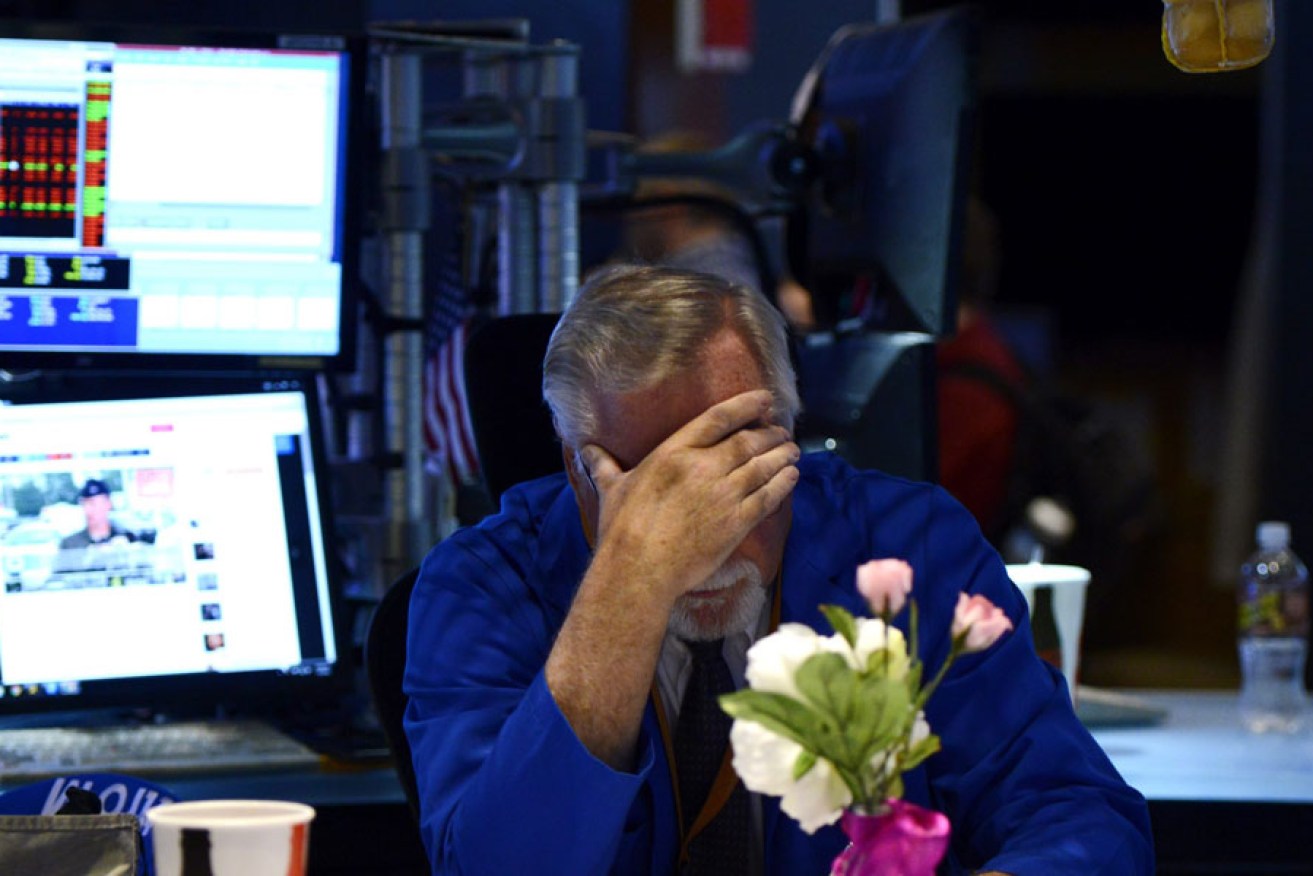 A trader sits at his desk after trading was halted due to a technical glitch in New York.