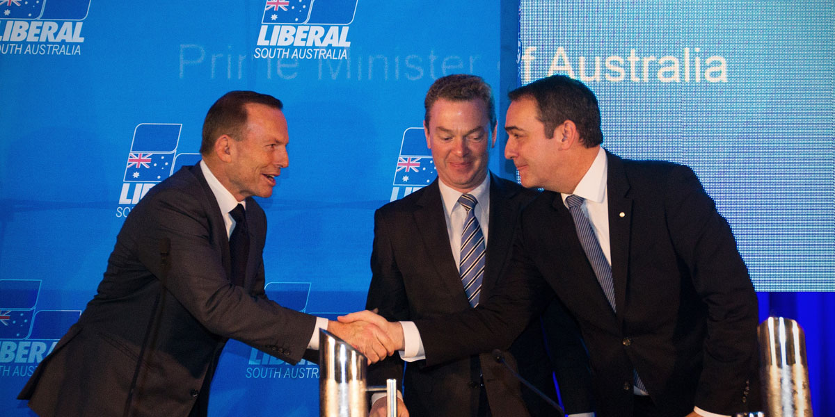 Prime Minister Tony Abbott shakes hands with South Australian Liberal leader Steven Marshall (right) as federal minister Christopher Pyne looks on. 