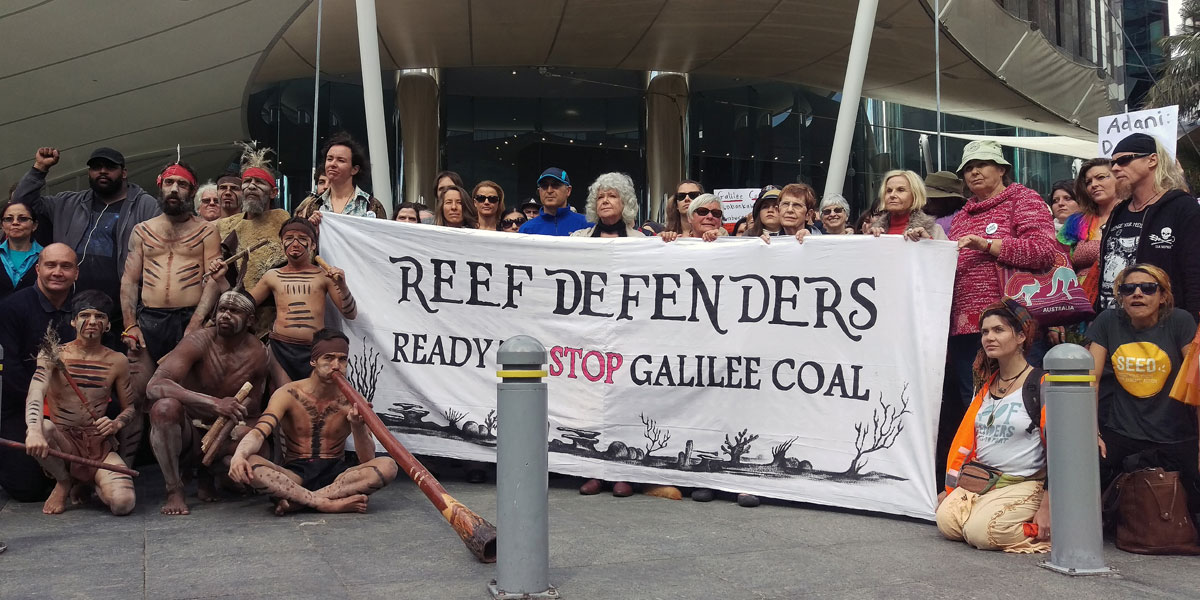 Anti-mining protesters  outside mining giant Adani's offices during a rally in Brisbane in July. AAP image