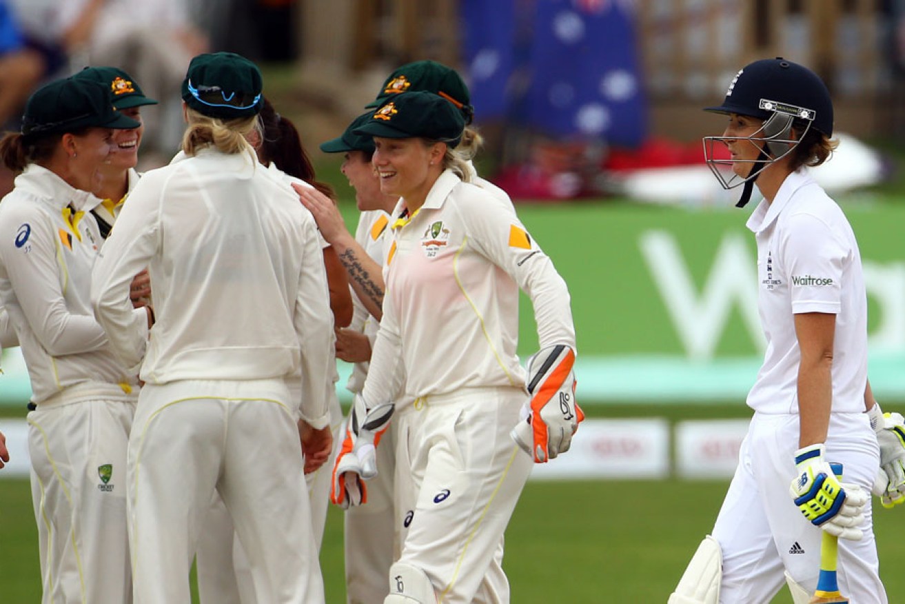 England Captain Charlotte Edwards (right) leaves the field after losing her wicket to Australia's Megan Schutt.