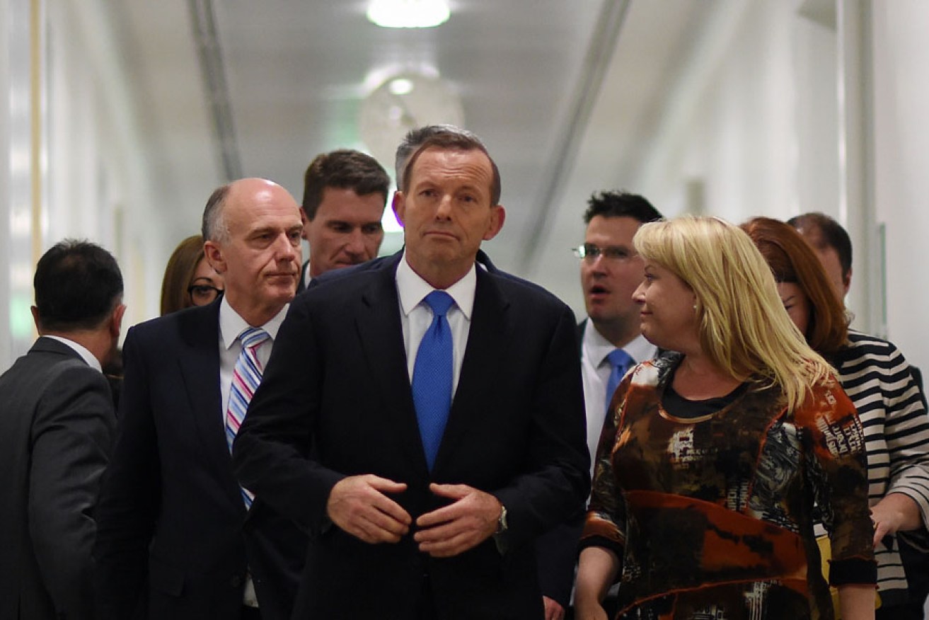 Tony Abbott surrounded by supporters last night after his defeat in the leadership ballot. AAP image