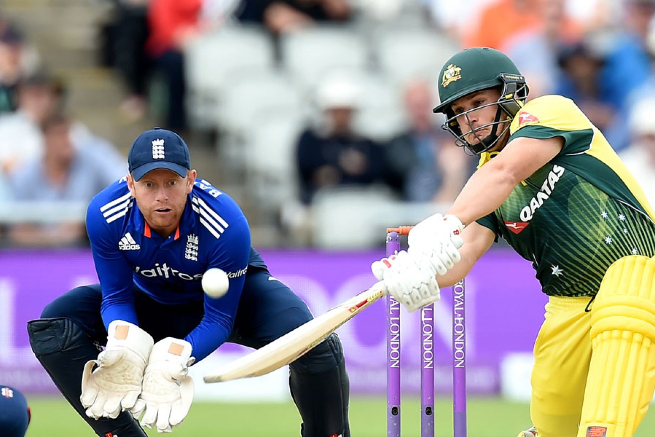 Australia's Aaron Finch sends the ball on its way for six, while wide-eyed England wicket keeper Jonny Bairstow looks on.
