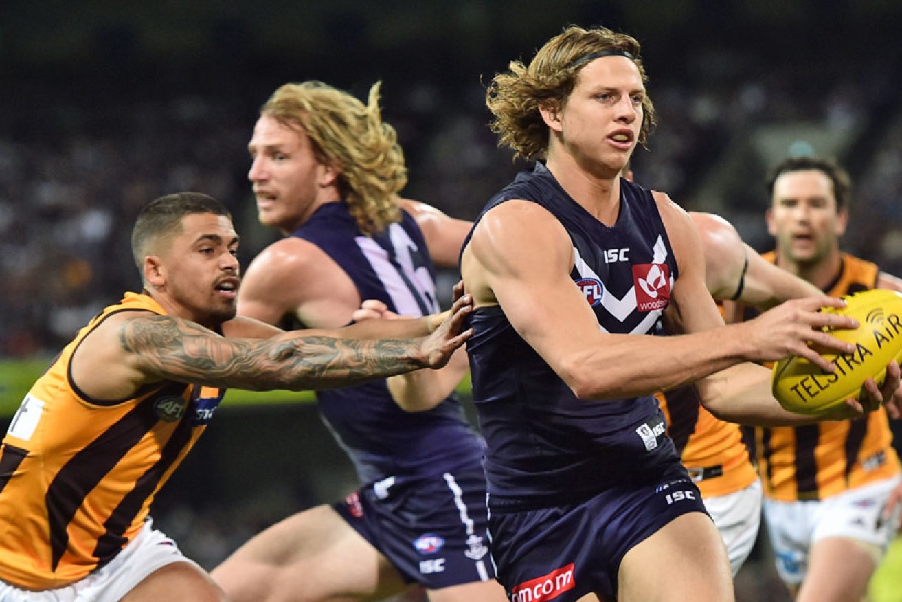 Nat Fyfe (right) will take over the Dockers captaincy from David Mundy (left). Photo: AAP
