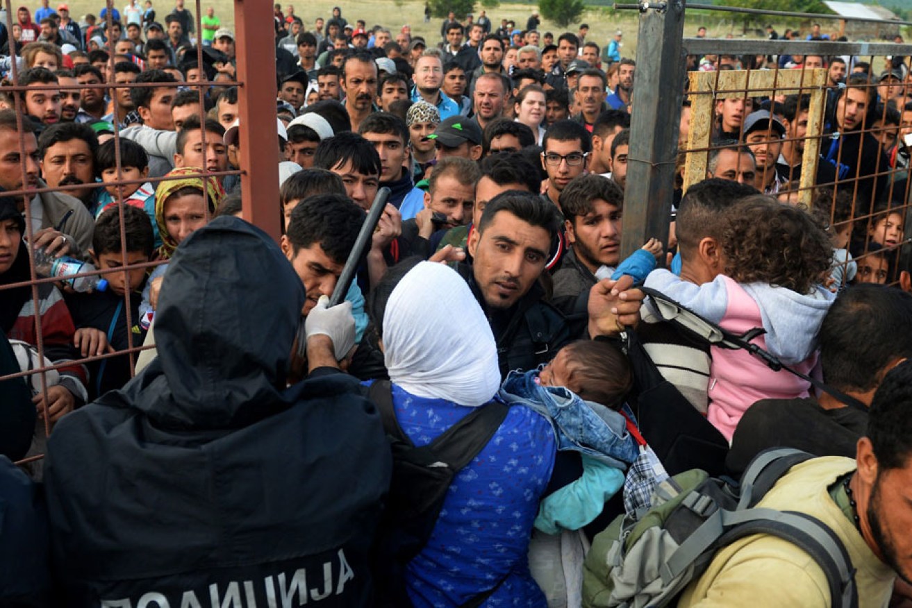 Migrants break through the cordon of Macedonian police forces, near the town of Gevgelija, in The Former Yugoslav Republic of Macedonia, 07 September 2015. EPA image