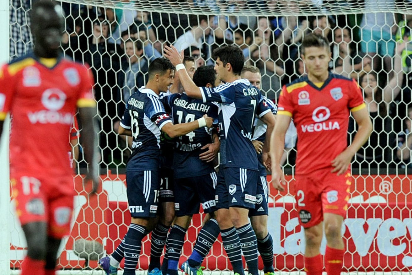 Melbourne Victory players celebrate a goal during the 2014/15 season. AAP image