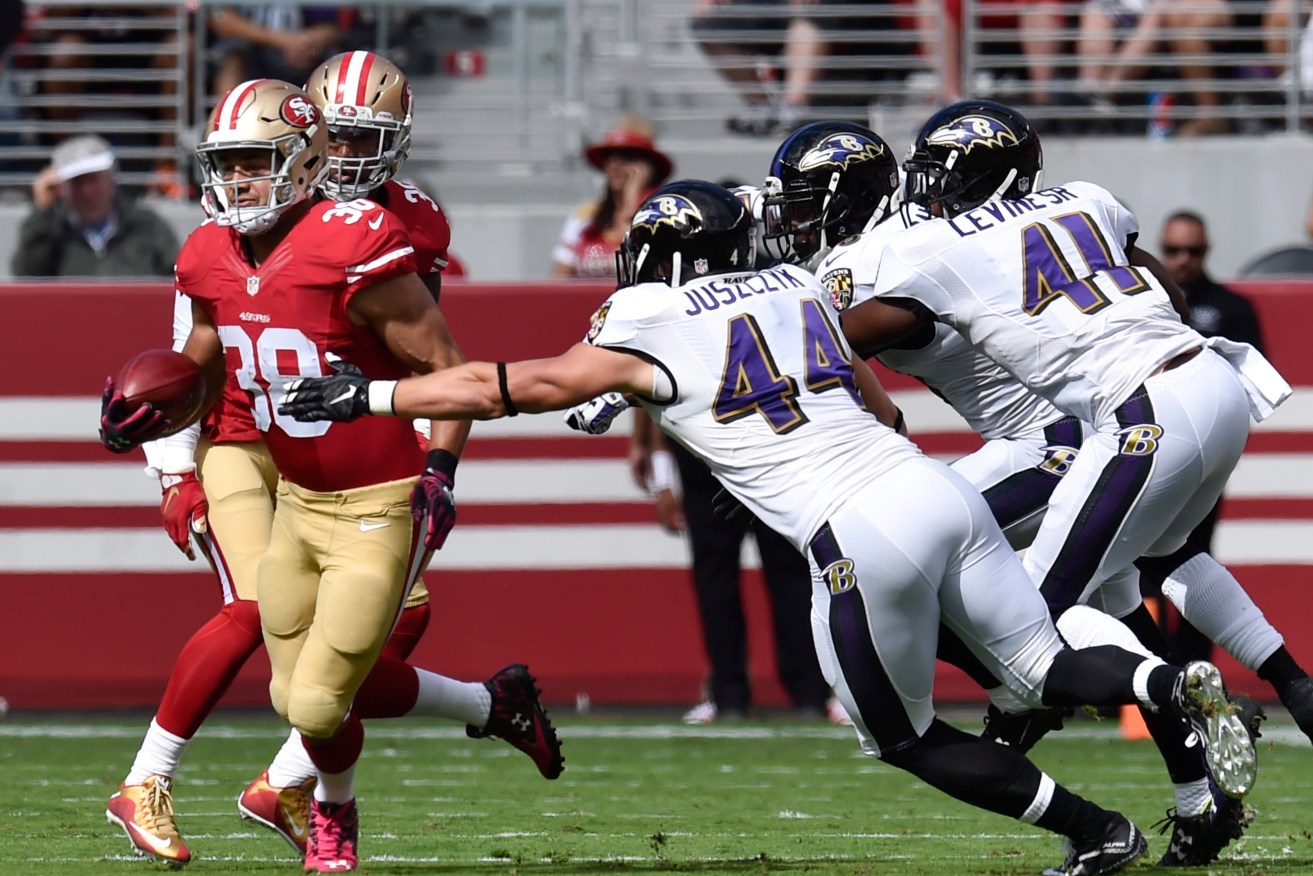 Hayne tries to elude a tackle by Baltimore Ravens fullback Kyle Juszczyk.