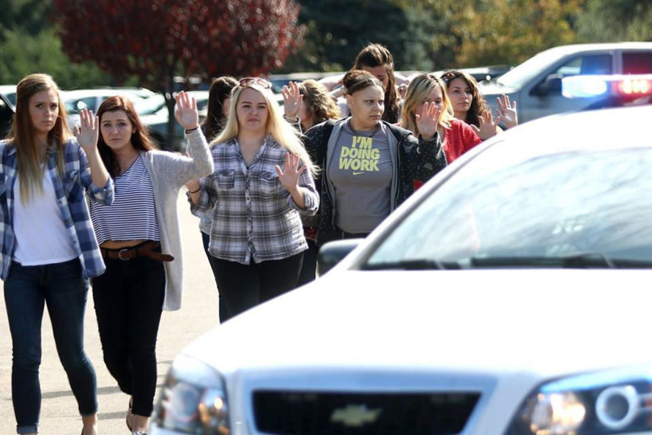 Students, staff and faculty are evacuated from Umpqua Community College in Roseburg, Oregon, after a deadly shooting.  AFP image