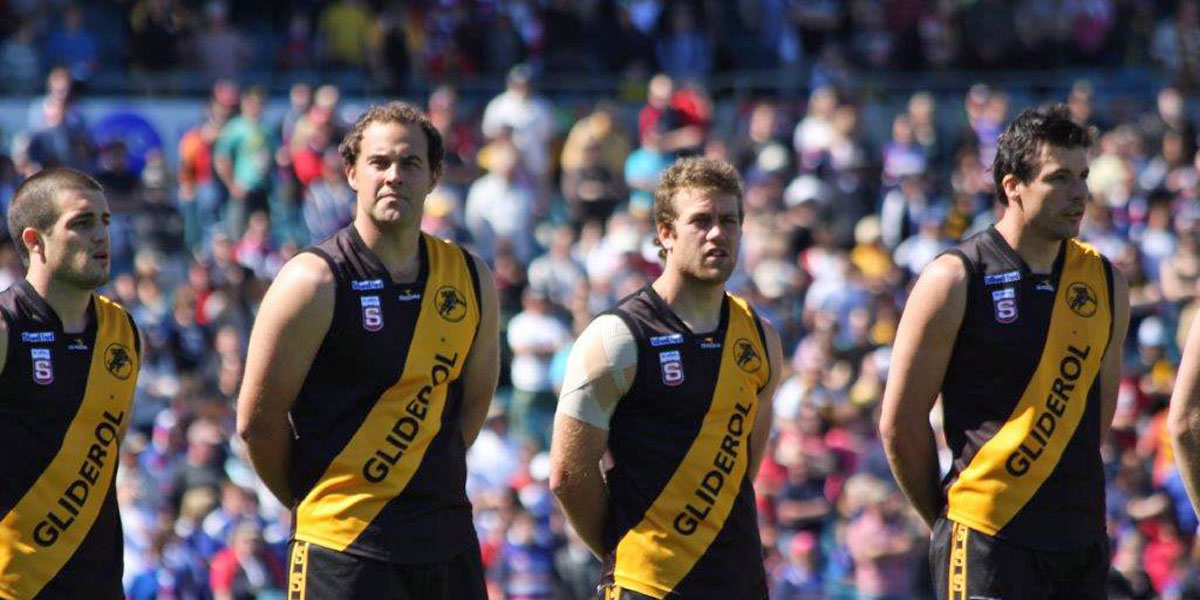 Left to right: Josh Willoughby, Matt Duldig, Ty Allen and Paul Sherwood listen to the national anthem before the 2008 SANFL grand final.