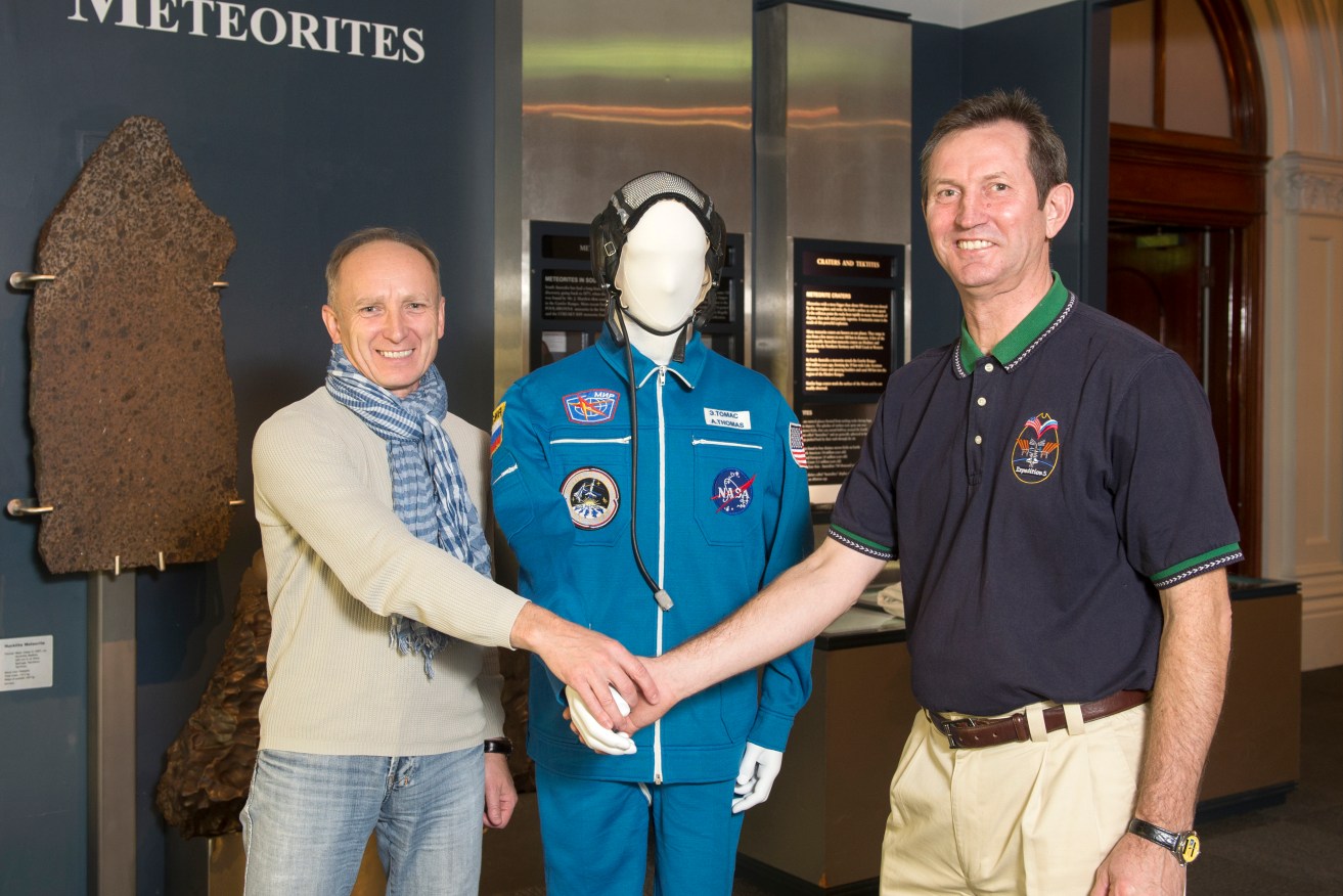 Yuri Gagarin Research and Test Cosmonaut Training Centre senior consultants Professor Alex Akulov and Sergey Treshcheov with US astronaut Andy Thomas’s display at the SA Museum. 