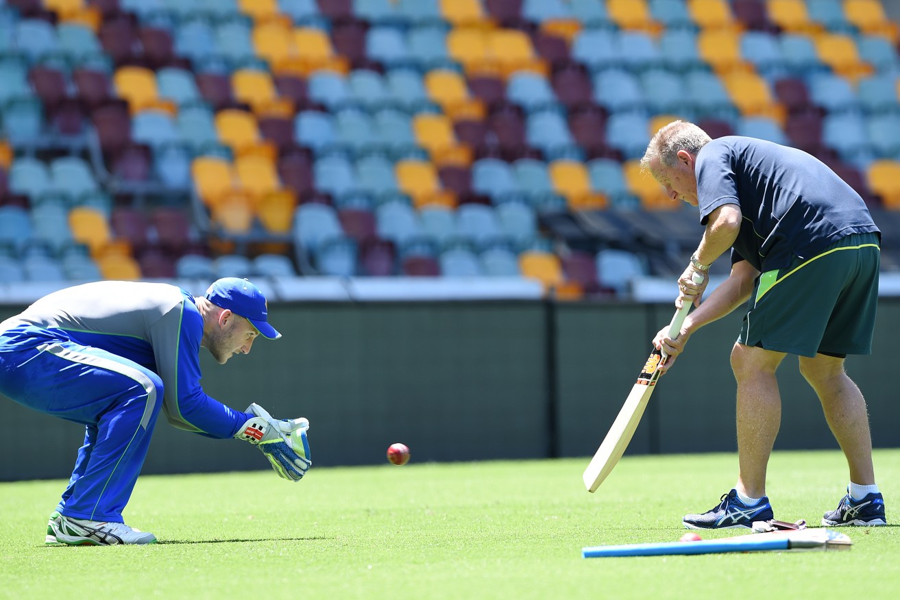 Australian wicket keeper Peter Nevill practices with former Australian keeper Ian Healy at the Gabba yesterday. 