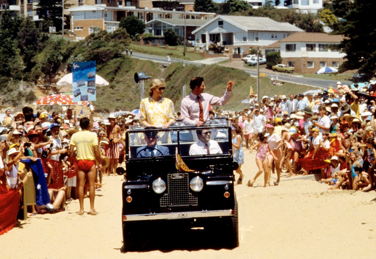 Princess Diana and Prince Charles wave to the public while driving on a beach in Australia. January 31 1988