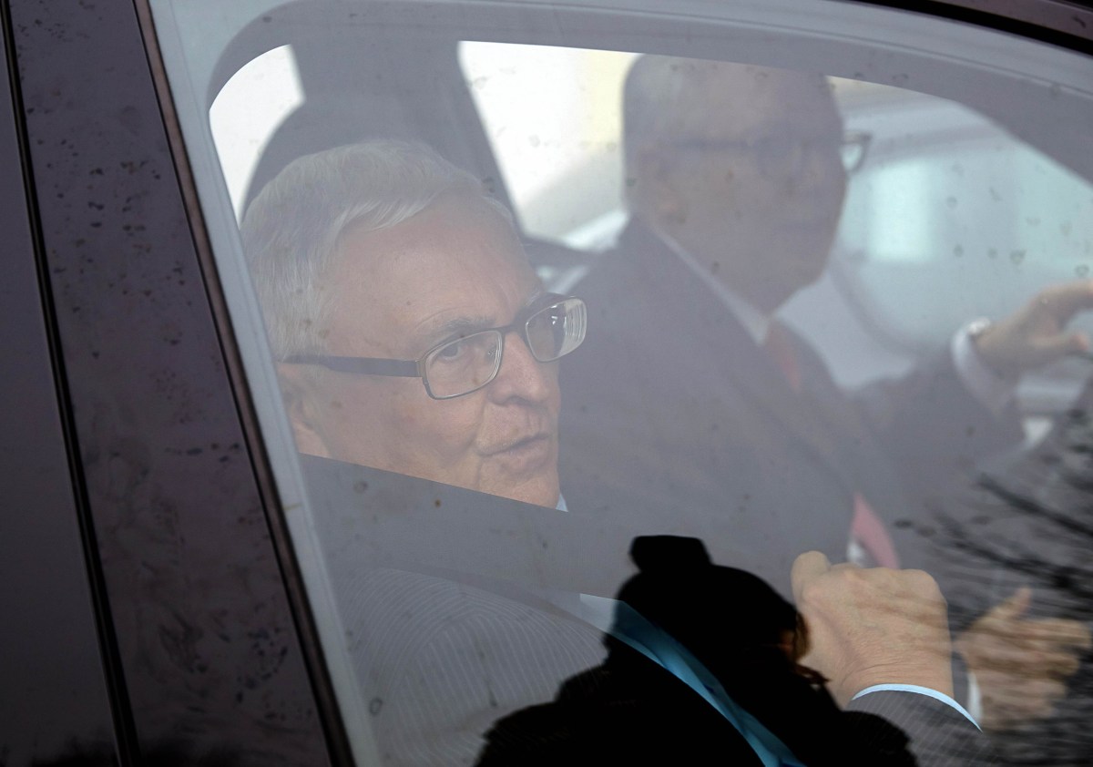 Former President of the German Football Federation (DFB) Theo Zwanziger (L) leaves by car after giving a press statement at a hotel in Diez, western Germany, as police raided offices of the DFB and homes of top officials on November 3, 2015 over tax evasion allegations, as a scandal surrounding graft claims over the awarding of the 2006 World Cup widened. The concerned officials are understood to be current DFB chief Wolfgang Niersbach, his predecessor Theo Zwanziger and ex-general secretary Horst Schmidt. AFP PHOTO / DPA / THOMAS FREY +++ GERMANY OUT