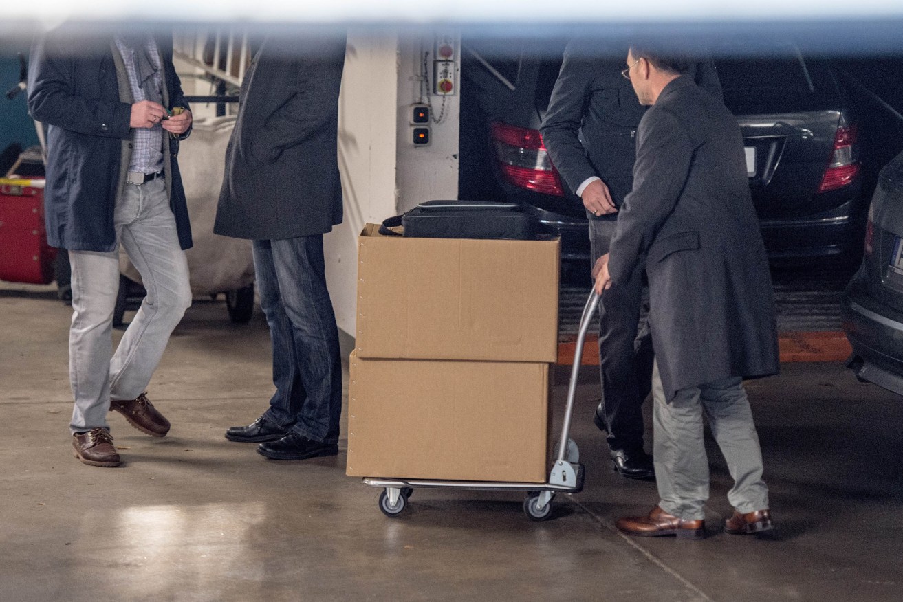 Investigators of the tax office move boxes of files in the garage of the German Football Federation (DFB) in Frankfurt.