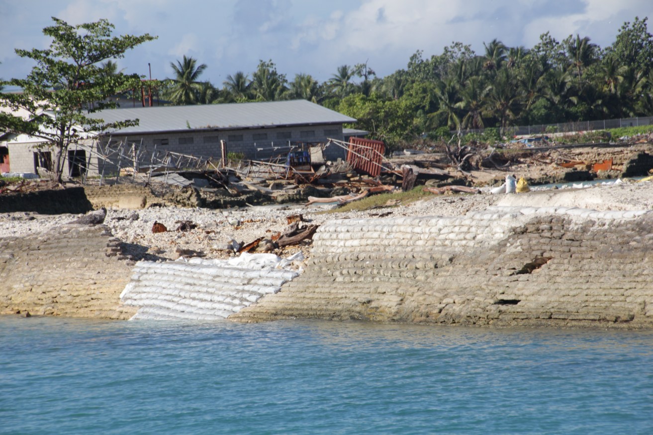 Locals in Kiribati begin constructing a sea wall to help protect the low-lying Pacific island from inundation. AAP Image/Elise Scott