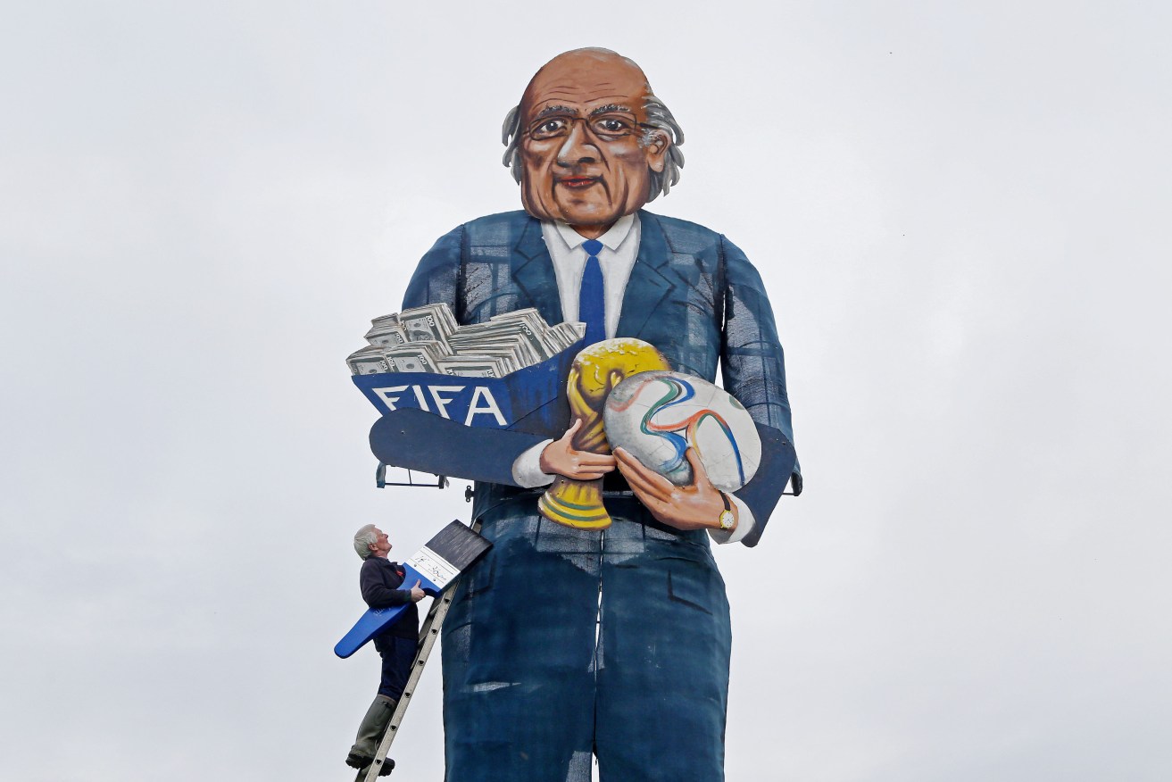 Artist Frank Shepherd puts the final touches to the Edenbridge Bonfire Society's celebrity 'guy', FIFA president Sepp Blatter.