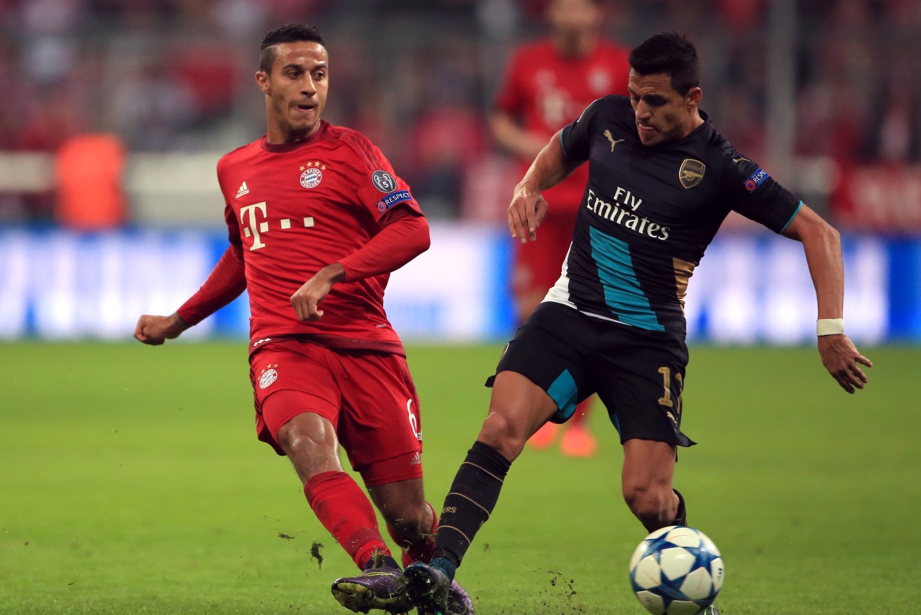 Bayern Munich's Thiago Alcantara (left) and Arsenal's Alexis Sanchez battle for the ball.