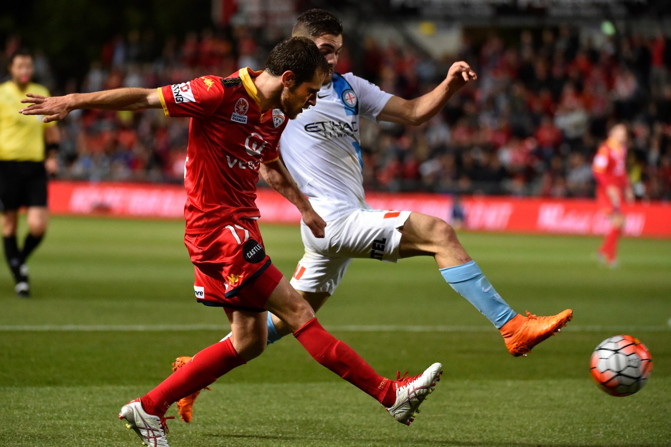 United's Mate Dugandzic takes on Ben Garucio of Melbourne City.