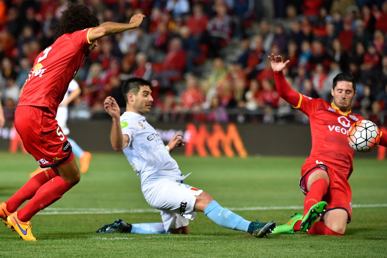 Melbourne City's Bruno Fornaroli gets the ball past Dylan McGowan last night.
