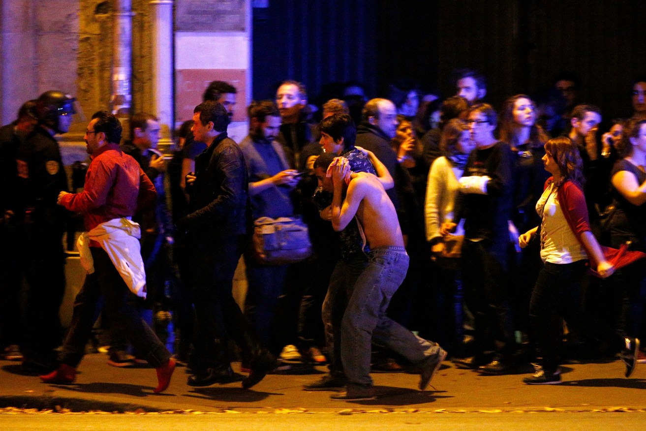 Wounded people are evacuated outside the scene of a hostage situation at the Bataclan theatre in Paris.