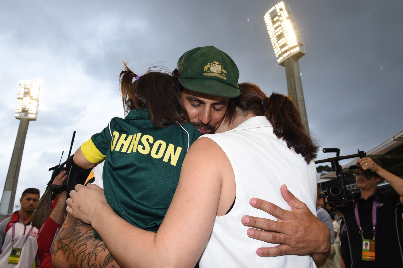 Mitchell Johnson hugs his wife and daughter at the end of the Perth Test - his last. AAP Image/Dave Hunt