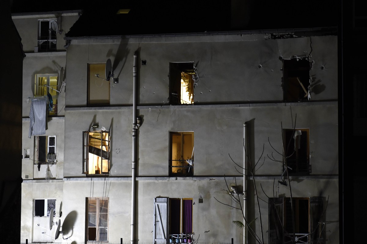 Picture taken of the building in the northern Paris suburb of Saint-Denis, on November 18, 2015, where French Police special forces raided an apartment, hunting those behind the attacks that claimed 129 lives in the French capital five days ago. French police said the assault had concluded on an apartment in northern Paris on November 18 in which at least two jihadists were killed and seven arrested.  AFP PHOTO / ERIC FEFERBERG
