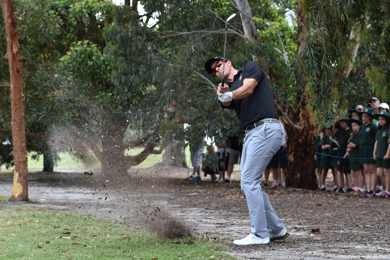 Adam Scott plays a shot at Huntingdale Golf Course in the first round of the Australian Masters Golf Tournament. AAP Image/Julian Smith