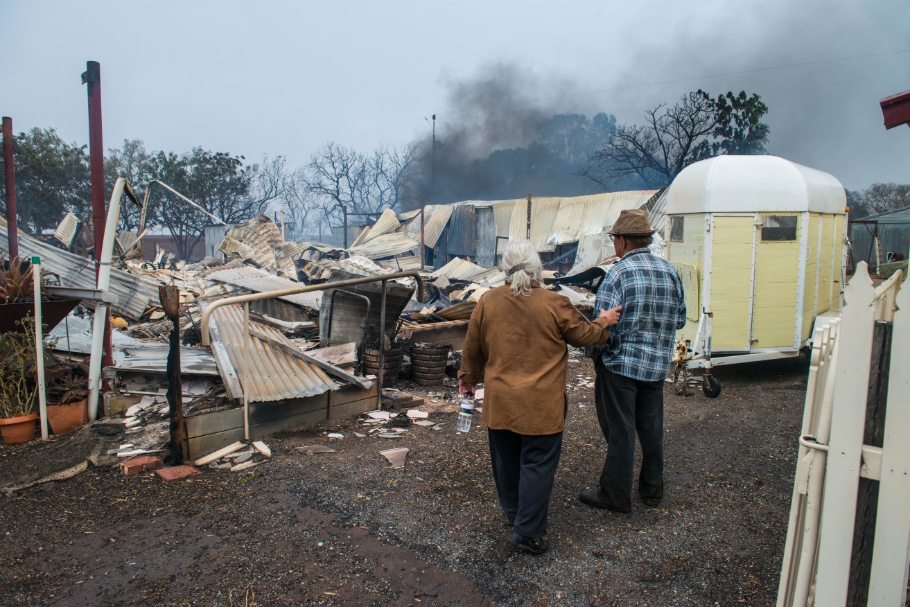 Property owners Jim and Lorraine inspect their destroyed house near Roseworthy in the mid-north. AAP Image/Brenton Edwards
