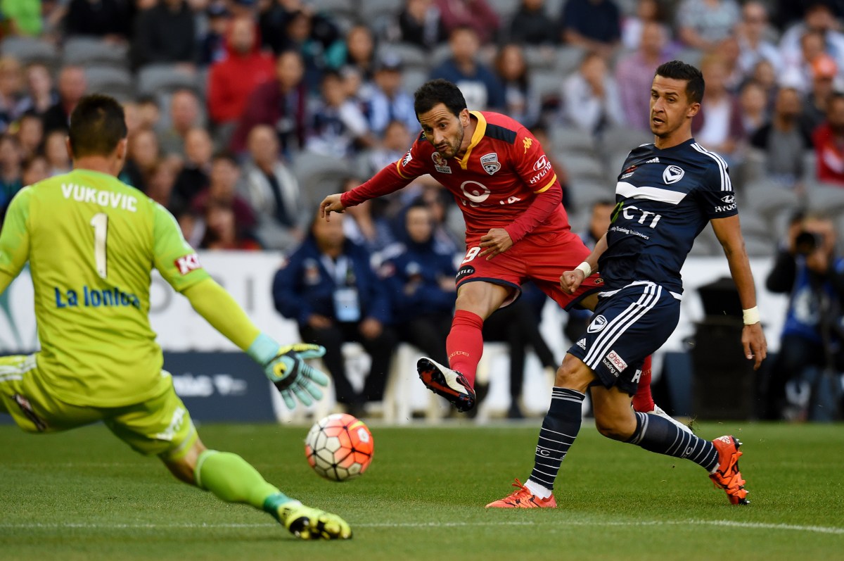 Sergio Cirio of Adelaide United tries to slip the ball past Victory 'keeper Daniel Vukovic. AAP Image/Tracey Nearmy