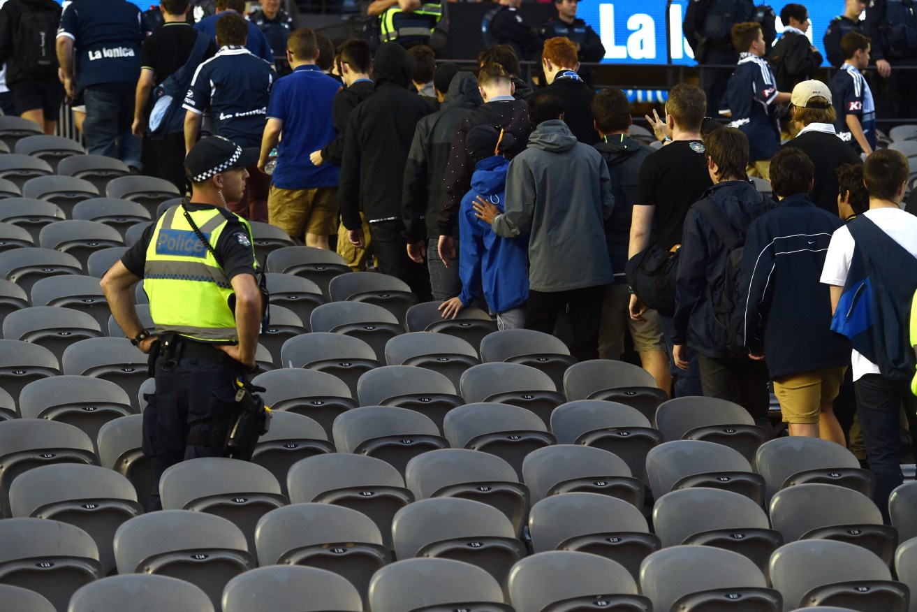 Melbourne Victory fans walk out at the 30th minute of the match against Adelaide United. AAP Image/Tracey Nearmy