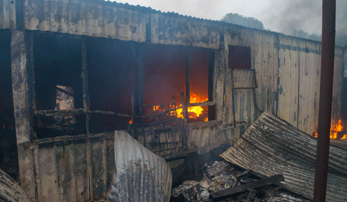 A destroyed house still burns near Roseworthy. Photo: AAP / Brenton Edwards.