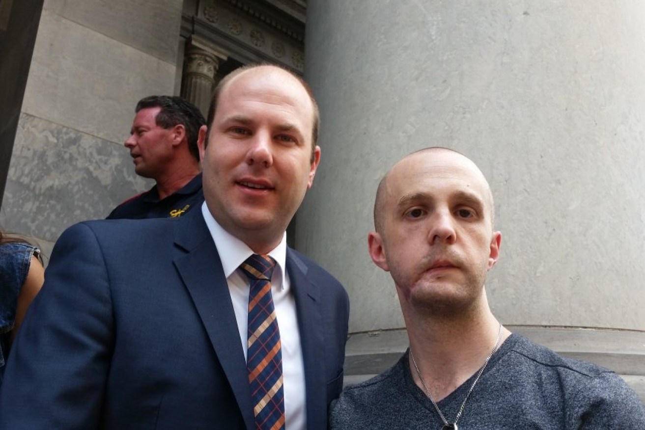 Liberal Sam Duluk at yesterday's rally with injured police officer Senior Constable Brett Gibbons, whose case has been used to push for amendments to compensation laws. Photo: Twitter.