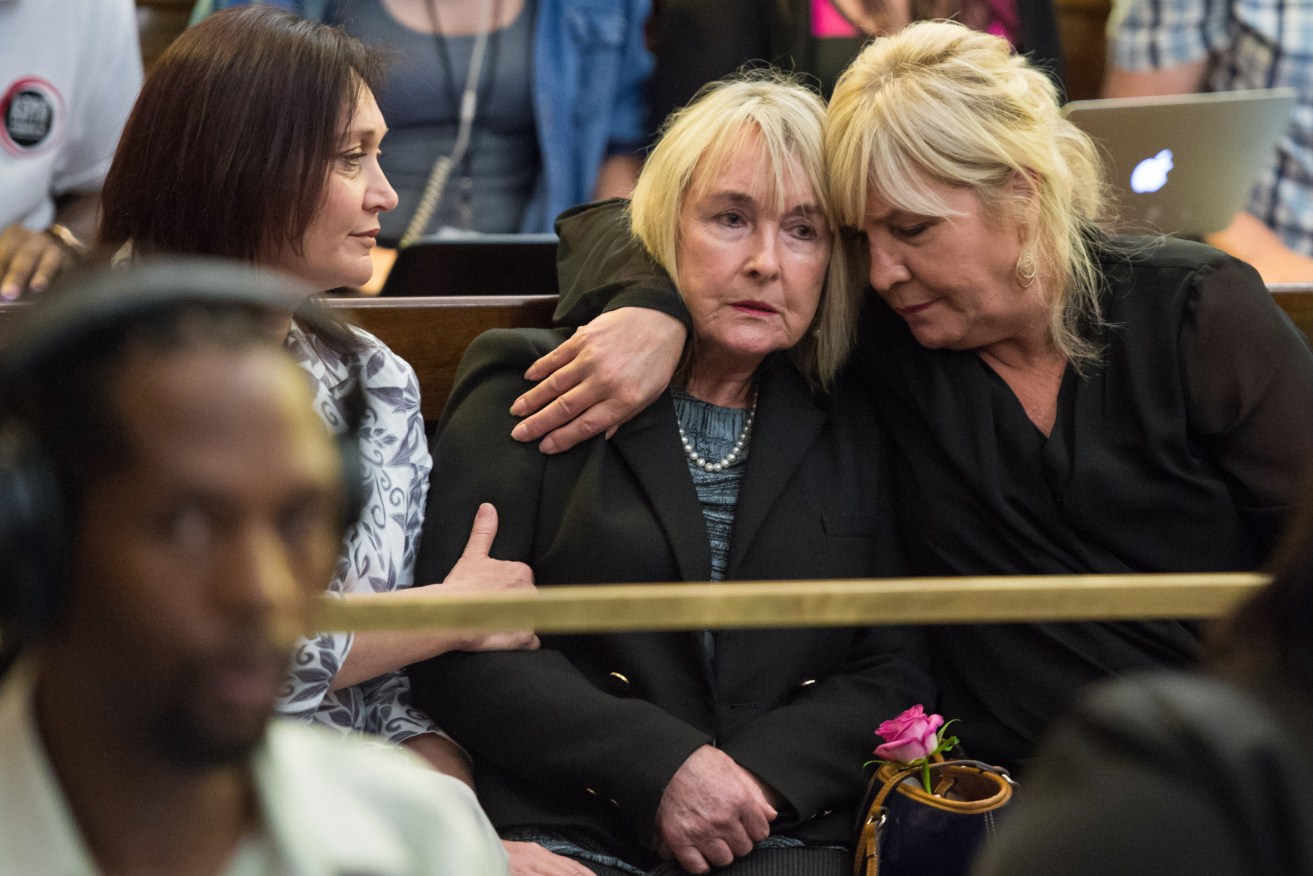 June Steenkamp (centre) the mother of Reeve Steenkamp, is comforted as judge Eric Leach reads out his finding. 
AFP/JOHAN PRETORIUS