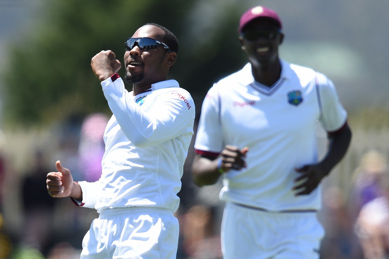 West Indies bowler Jomel Warrican celebrates afer claiming the key wicket of Steve Smith for 10. AAP Image/Dave Hunt