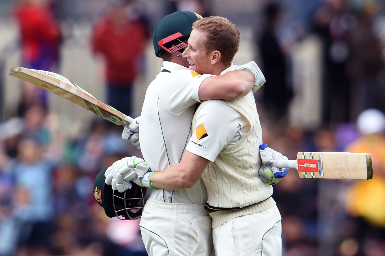 Adam Voges (right) embraces teammate Shaun Marsh after scoring his double century.  AFP PHOTO / William WEST   
